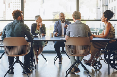 Diverse group of people having a discussion at a table