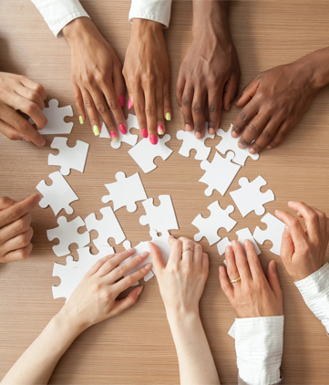 Diverse group of people putting a puzzle together