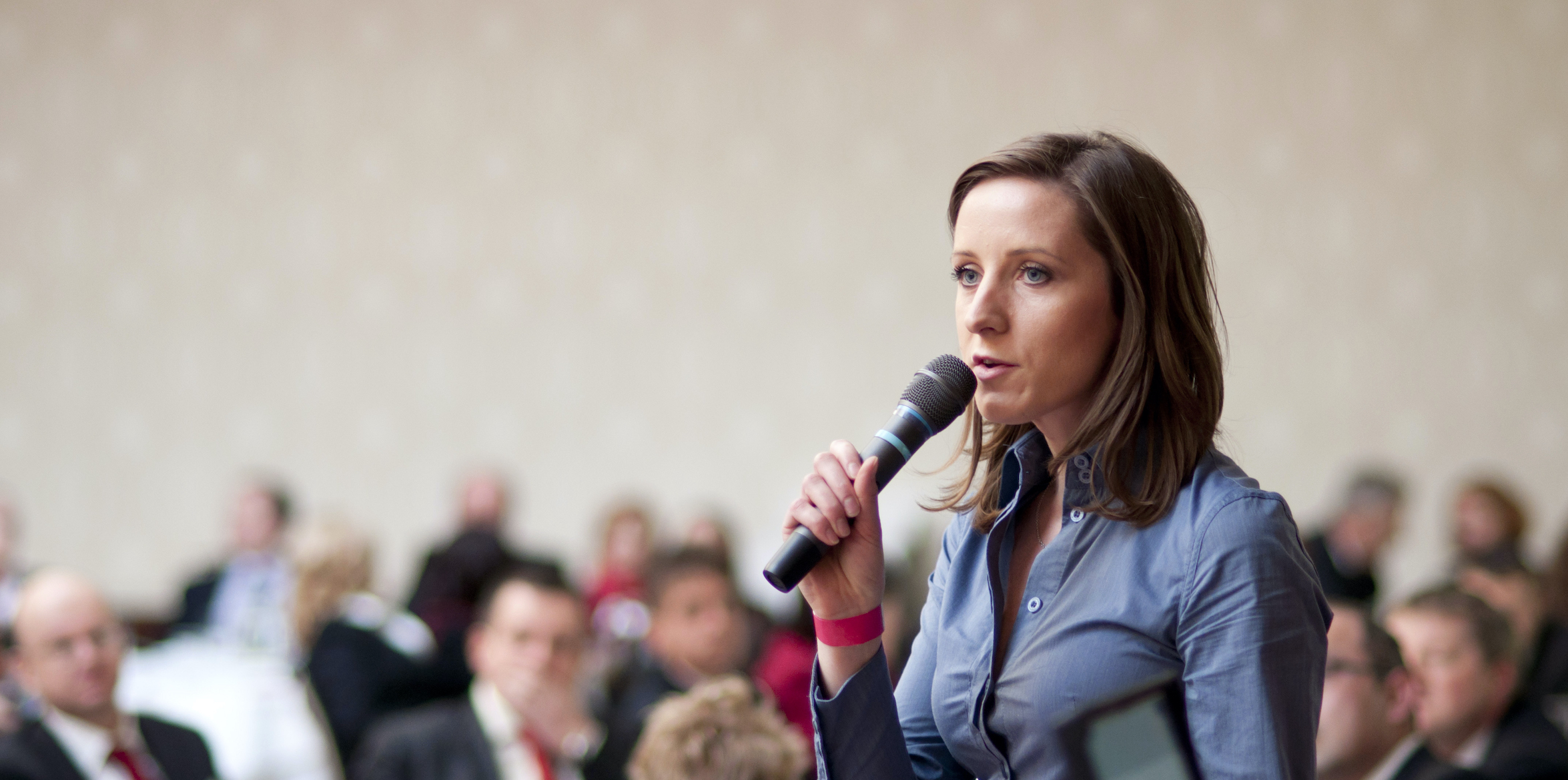 Woman speaking itno a microphone