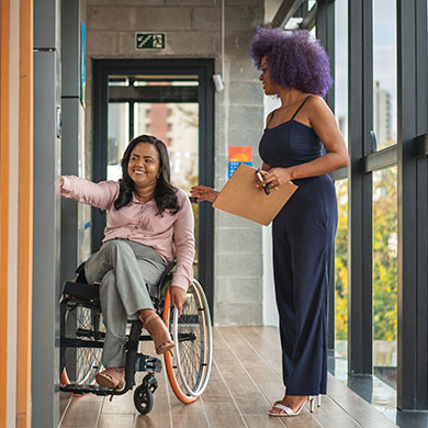 Female property manager helping tenant in wheelchair