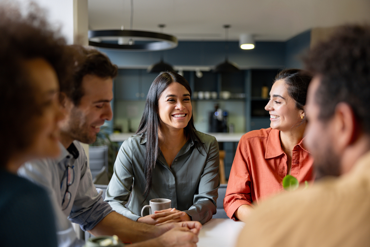 Woman smiling in a group discussion