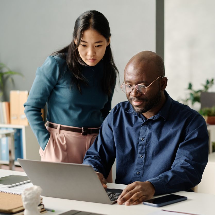 Man and woman looking at a laptop screen